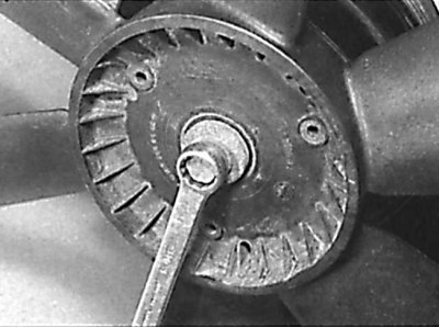 Unscrewing the central bolt securing the radiator fan