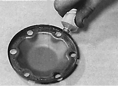 Applying a layer of grease to the inner end of the protective cover
