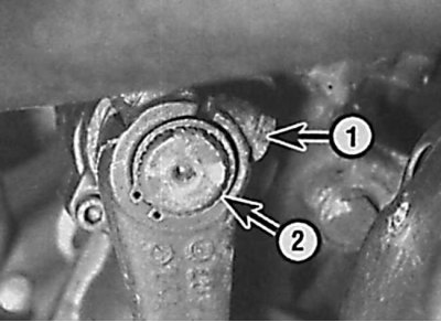 Location of bolt (1) and retaining ring (2) for fastening the steering arm to the steering gear
