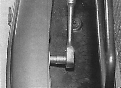 Unscrewing the nut located in the center of the bumper at its top