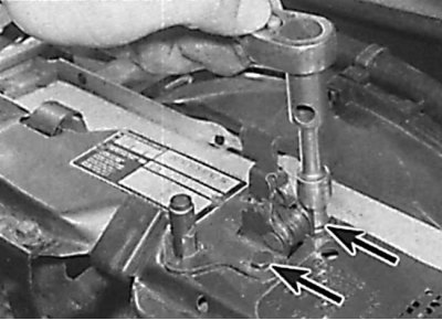 Unscrewing the hood lock mounting bolts