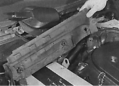 Removal the insulating panel located between the windshield wiper motor and the heater fan housing