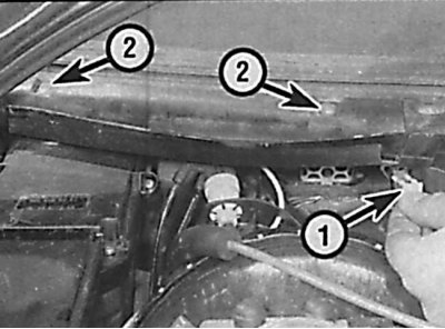 Location of the mounting bracket (1) and screws (2) securing the side section of the heater fan…