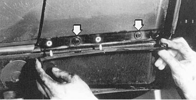 Fig. 11.9. Under the decorative panel there are two bolts (arrows) for fastening the wing