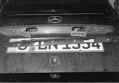 Fig. 9.28. To replace the license plate light bulbs on a sedan, first unscrew the trunk lid handle