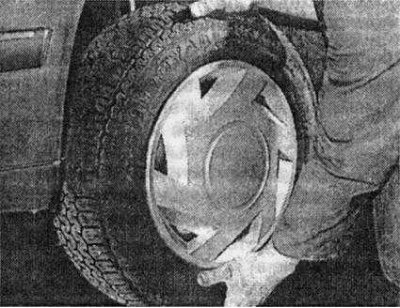 Twist the wheel sharply to check for excessive play in the bearings and suspension components